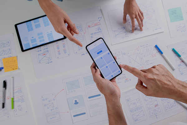 Deux stagiaires en formation Mobile et Tactile chez Usabilis discutent sur le design d'une application mobile.